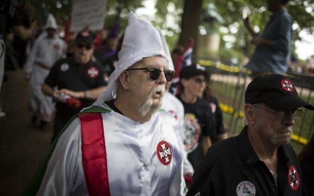 A Ku Klux Klan member is escorted out of Justice Park after a planned protest by the Klan on July 8, 2017 in Charlottesville, Virginia. (Chet Strange/Getty Images/AFP)