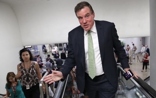 Sen. Mark Warner (D-VA), vice chairman of the Senate Select Committee on Intelligence, speaks to reporters while walking to a vote on the Senate floor at the U.S. Capitol July 12, 2017 in Washington, DC. (Win McNamee/Getty Images/AFP)