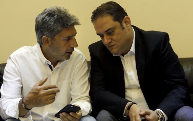 Ziad Zakka, left, brother of Nizar Zakka who is imprisoned in Iran, speaks with his brother's lawyer Majed Dimshkiyeh in Beirut, Lebanon, Tuesday, July 18, 2017. (AP/Bilal Hussein)