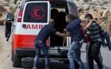 Illustrative: An injured Palestinian is evacuated by ambulance during clashes with Israeli soldiers after troops searched and measured family house of Omar al-Abed, 20, perpetrator of Friday's attack at the West Bank settlement of Halamish, in preparation for demolition, in the West Bank village of Kobar, near Ramallah, July 22, 2017. (AP Photo/Nasser Nasser)