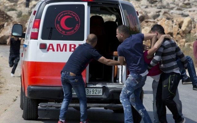 Illustrative: An injured Palestinian is evacuated by ambulance during clashes with Israeli soldiers after troops searched and measured family house of Omar al-Abed, 20, perpetrator of Friday's attack at the West Bank settlement of Halamish, in preparation for demolition, in the West Bank village of Kobar, near Ramallah, July 22, 2017. (AP Photo/Nasser Nasser) Illustrative: An injured Palestinian is evacuated by ambulance during clashes with Israeli soldiers after troops searched and measured family house of Omar al-Abed, 20, perpetrator of Friday's attack at the West Bank settlement of Halamish, in preparation for demolition, in the West Bank village of Kobar, near Ramallah, July 22, 2017. (AP Photo/Nasser Nasser)