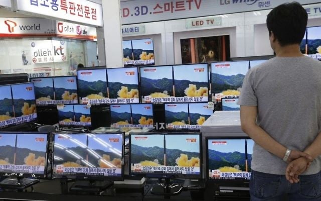 In this July 6, 2017 file photo, a man watches TV screens in an electronics shop showing a news program's report on North Korea's missile firing in Seoul, South Korea. (AP Photo/Ahn Young-joon, File)