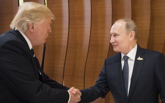 In this photo provided by German government, US President Donald Trump (L) shakes hand with Russian President Vladimir Putin before the first working session of the G-20 summit in Hamburg, Germany. (Steffen Kugler/Presse- und Informationsamt der Bundesregierung via AP)