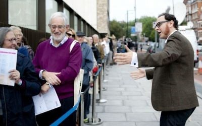 Chief executive Raymond Simonson greeting visitors at the opening of London’s JW3 community center in 2013. (Blake Ezra Photography via JTA)