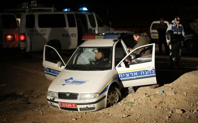 Police inspect a cruiser after the killing of two policemen in the Jordan Valley on March 15, 2009. (Kobi Gideon/FLASH90) Police inspect a cruiser after the killing of two policemen in the Jordan Valley on March 15, 2009. (Kobi Gideon/FLASH90)