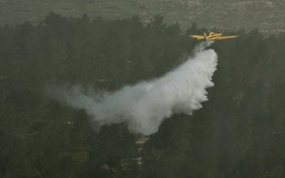 Illustrative: A firefighting plane dumps water on a forest in the Judean Hills during an exercise on March 29, 2012. (Omer Miron/Flash90) Illustrative: A firefighting plane dumps water on a forest in the Judean Hills during an exercise on March 29, 2012. (Omer Miron/Flash90)