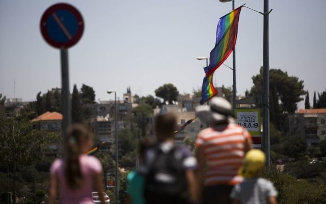 Israelis pass by rainbow flags in Jerusalem ahead of the Jerusalem Pride Parade, on July 31, 2013 (Yonatan Sindel / Flash90) Israelis pass by rainbow flags in Jerusalem ahead of the Jerusalem Pride Parade, on July 31, 2013 (Yonatan Sindel / Flash90)