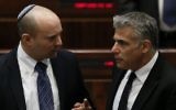 Jewish Home chair Naftali Bennett (L) speaks with Yesh Atid chair Yair Lapid in the Knesset plenum, March 11, 2014. (Miriam Alster/Flash90)