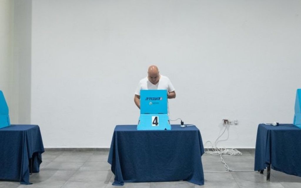 A member of Israel's Labor party casts a ballot at a polling station in Jerusalem on July 10, 2017. (Yonatan Sindel/Flash90)