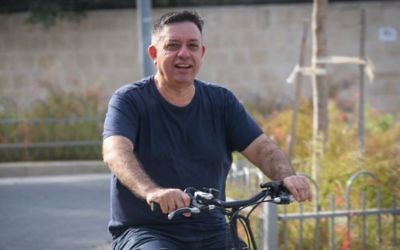 Newly elected head of the Labor party, Avi Gabbay, seen riding his bicycle outside his home on July 11, 2017. (Flash90)