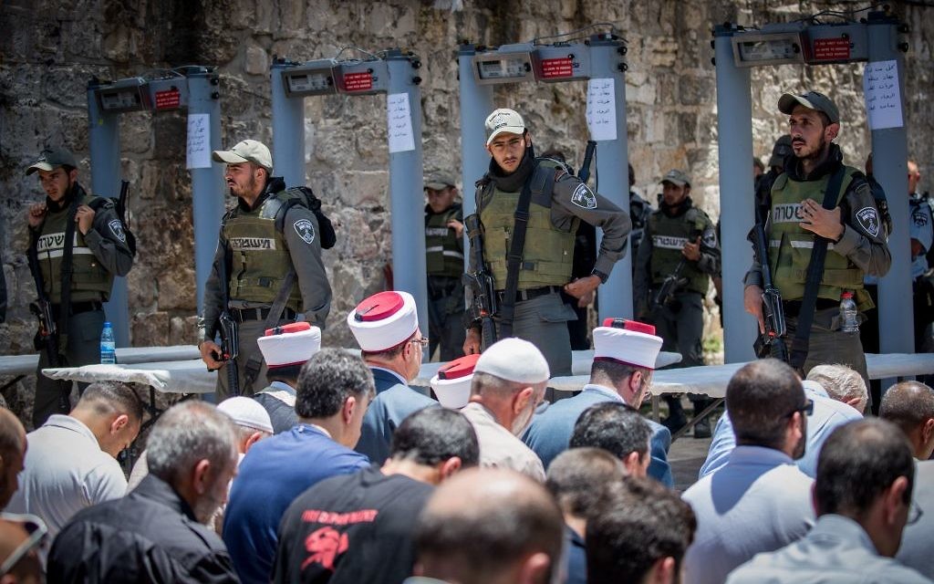 File: Waqf officials lead Muslim prayers outside the Temple Mount in Jerusalem's Old City on July 16, 2017, after refusing to go through metal detector gates set up by Israeli police. The gates were later removed. (Yonatan Sindel/Flash90) File: Waqf officials lead Muslim prayers outside the Temple Mount in Jerusalem's Old City on July 16, 2017, after refusing to go through metal detector gates set up by Israeli police. The gates were later removed. (Yonatan Sindel/Flash90)