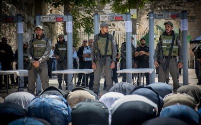 Muslims pray in front of metal detectors placed outside the Temple Mount, in Jerusalem's Old City, July 16, 2017. (Yonatan Sindel/Flash90) Muslims pray in front of metal detectors placed outside the Temple Mount, in Jerusalem's Old City, July 16, 2017. (Yonatan Sindel/Flash90)