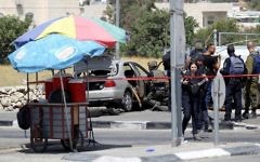 Israeli security forces gather at the scene of a car-ramming attack at the entrance to the West Bank village of Beit Anoun on July 18, 2017. ( Wisam Hashlamoun/Flash90)