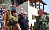 Defense Minister Avigdor Liberman (center) walks before IDF Chief of Staff Gadi Eisenkot (4th left) as they visit the site of a terror attack in the settlement of Halamish, July 22, 2017. (Ariel Hermoni/Ministry of Defense via Flash90)