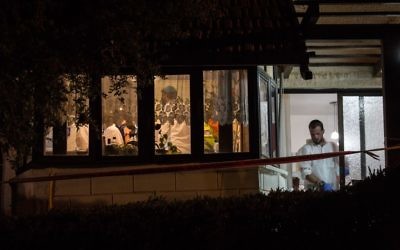 Zaka personnel and police inside the Halamish home where three Israelis were killed by a Palestinian terrorist, on July 22, 2017. (Hadas Parush/FLASH90)