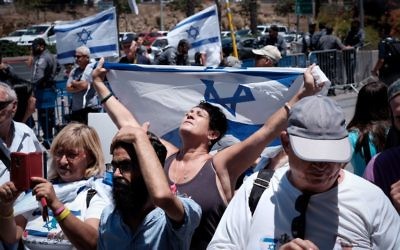 Supporters of Elor Azaria, the Israeli soldier convicted in the March 2016 manslaughter of a Palestinian attacker, demonstrate outside the military court at IDF Headquarters at the Kirya base in Tel Aviv, July 30, 2017. (Tomer Neuberg/Flash90) Supporters of Elor Azaria, the Israeli soldier convicted in the March 2016 manslaughter of a Palestinian attacker, demonstrate outside the military court at IDF Headquarters at the Kirya base in Tel Aviv, July 30, 2017. (Tomer Neuberg/Flash90)