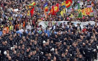 Riot Police officers escort a protest rally against the G-20 summit in Hamburg, northern Germany, Saturday, July 8, 2017. (AP Photo/Michael Probst)
