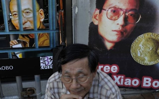 A protester sits in front of pictures of jailed Chinese Nobel Peace laureate Liu Xiaobo during a demonstration outside the Chinese liaison office in Hong Kong, Thursday, July 13, 2017. (AP Photo/Vincent Yu) A protester sits in front of pictures of jailed Chinese Nobel Peace laureate Liu Xiaobo during a demonstration outside the Chinese liaison office in Hong Kong, Thursday, July 13, 2017. (AP Photo/Vincent Yu)