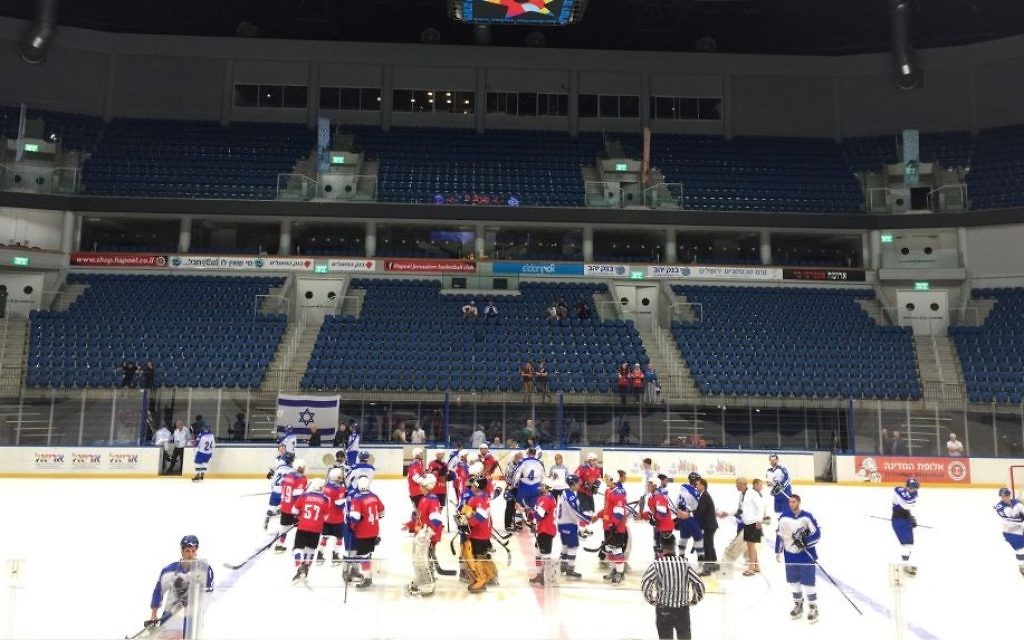 Russian (in red) and Israeli Maccabiah teams shaking hands after Sunday's match, which ended 5 to 3, Russia (Jessica Steinberg/Times of Israel) Russian (in red) and Israeli Maccabiah teams shaking hands after Sunday's match, which ended 5 to 3, Russia (Jessica Steinberg/Times of Israel)
