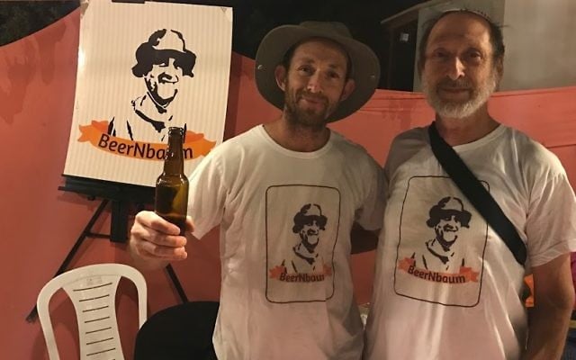 Mickey Birnbaum (L) and his father Eli selling their "Beer'nbaum beer at the Tekoa Beer Festival on July 6, 2017. (Jacob Magid/Times of Israel)