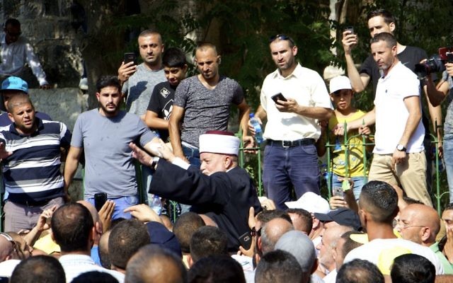 On July 27, 2017, Jerusalem's Mufti Mohammed Hussein is hoisted onto the shoulders of worshipers just before they enter the Temple Mount / Al Aqsa Compound for the first time in 12 days. (Dov Lieber / Times of Israel) 