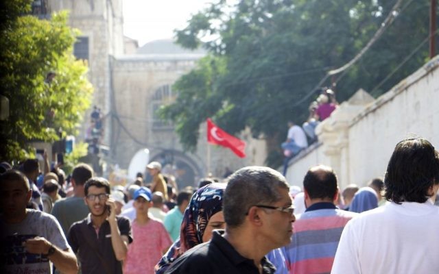 Muslim Worshipers at the Lions Gate who refused to enter the Temple Mount Compound on July 27, 2017, even after thousands began pour onto the holy site. One protester waves a Turkish flag. (Dov Lieber / Times of Israel) 
