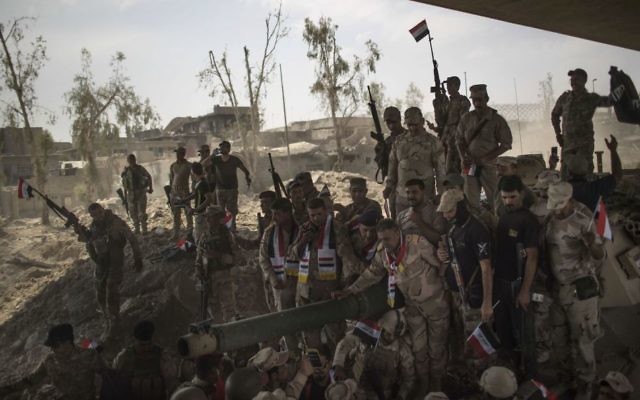 Iraqi Army soldiers gather to celebrate their gains as their fight against Islamic State continues in the Old City of Mosul, Iraq, Sunday, July 9, 2017. (AP Photo/Felipe Dana) Iraqi Army soldiers gather to celebrate their gains as their fight against Islamic State continues in the Old City of Mosul, Iraq, Sunday, July 9, 2017. (AP Photo/Felipe Dana)