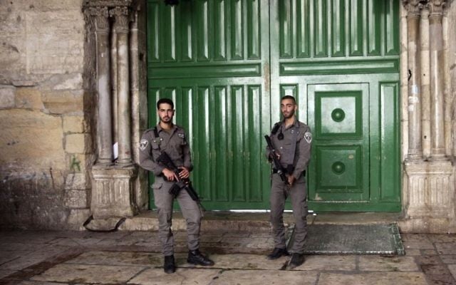 Israeli border police officers stand guard at the entrance to the Temple Mount compound in Jerusalem's Old City, Friday, July 14, 2017. (AP/Mahmoud Illean) Israeli border police officers stand guard at the entrance to the Temple Mount compound in Jerusalem's Old City, Friday, July 14, 2017. (AP/Mahmoud Illean)
