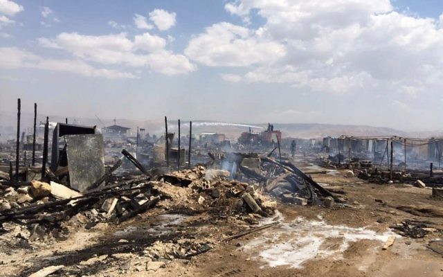 Lebanese Civil Defense workers putting out a fire in a Syrian refugee camp in Qab Elias, a village in the Bekaa Valley, Lebanon, Sunday, July 2, 2017. (Qab Elias Emergency Services via AP) Lebanese Civil Defense workers putting out a fire in a Syrian refugee camp in Qab Elias, a village in the Bekaa Valley, Lebanon, Sunday, July 2, 2017. (Qab Elias Emergency Services via AP)