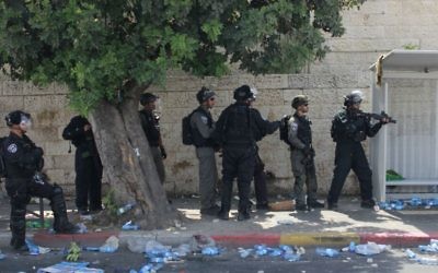 Border guards square off against protesters in the neighborhood of Wadi Joz during a riot there on July 21, 2017. (Judah Ari Gross/Times of Israel)