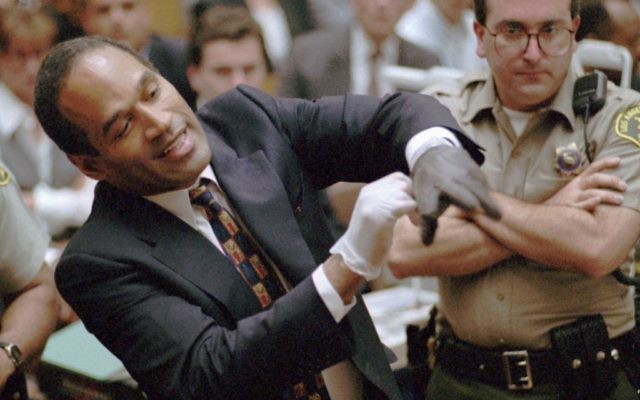 O.J. Simpson, left, grimaces as he tries on one of the leather gloves prosecutors say he wore the night his ex-wife Nicole Brown Simpson and Ron Goldman were murdered, during his trial in a Los Angeles courtroom, June 15, 1995. (AP/Sam Mircovich, Pool) O.J. Simpson, left, grimaces as he tries on one of the leather gloves prosecutors say he wore the night his ex-wife Nicole Brown Simpson and Ron Goldman were murdered, during his trial in a Los Angeles courtroom, June 15, 1995. (AP/Sam Mircovich, Pool)