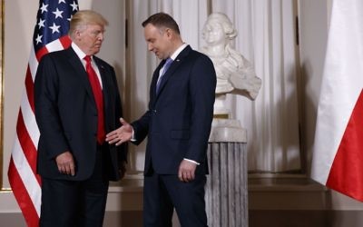 US President Donald Trump, left, is greeted by Polish President Andrzej Duda after arriving at the Royal Castle, Thursday, July 6, 2017, in Warsaw. (AP Photo/Evan Vucci)