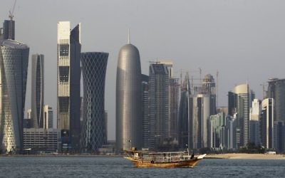 In this Thursday Jan. 6, 2011 file photo, a traditional dhow floats in the Corniche Bay of Doha, Qatar, with tall buildings of the financial district in the background. (AP/Saurabh Das, File)