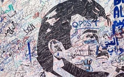 A black-and-white depiction of Qatar's emir, Sheikh Tamim bin Hamad Al Thani, attracts signatures and comments of support from residents amid a diplomatic crisis between Qatar and neighboring Arab countries in Doha, Qatar, on Monday, July 3, 2017. (AP Photo/Maggie Hyde)