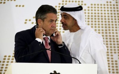 Emirati Foreign Minister Abdullah bin Zayed Al Nahyan whispers to German Foreign Minister Sigmar Gabriel during a news conference in Abu Dhabi, United Arab Emirates, Tuesday, July 4, 2017. (AP Photo/Jon Gambrell)