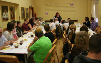 Golda Tencer, standing, at a Shabbat dinner during the International Seminar in Yiddish Language and Culture, July 7, 2017. (Katarzyna Markusz/JTA)