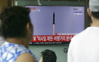 People watch a TV news program showing a file image of a missile being test-launched by North Korea, at the Seoul Railway Station in Seoul, South Korea, Tuesday, July 4, 2017 (AP Photo/Ahn Young-joon)