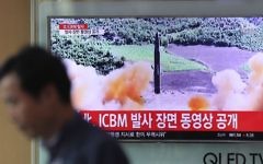 A man walks by a TV screen showing a local news program reporting about North Korea's missile firing at Seoul Train Station in Seoul, South Korea, Wednesday, July 5, 2017. (Lee Jin-man/AP)