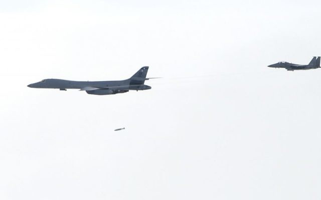 In this photo provided by South Korea Defense Ministry, A U.S. Air Force B-1B Lancer bomber, left, drops a bomb over the Korean Peninsula, South Korea Saturday, July 8, 2017. (South Korea Defense Ministry via AP) In this photo provided by South Korea Defense Ministry, A U.S. Air Force B-1B Lancer bomber, left, drops a bomb over the Korean Peninsula, South Korea Saturday, July 8, 2017. (South Korea Defense Ministry via AP)