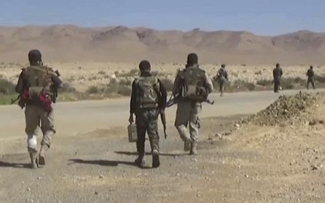 This frame grab from video released on May 26, 2017 and provided by the government-controlled Syrian Central Military Media, shows Syrian forces take up positions during fighting between government forces and Islamic State group militants in Homs province in central Syria (Syrian Central Military Media, via AP)