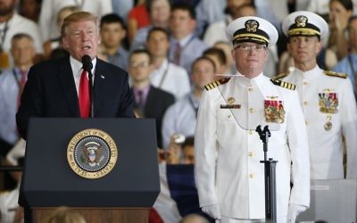 President Donald Trump, left, puts the USS Gerald Ford into commission as Ships commander Capt. Richard McCormack, front right, listens aboard the nuclear aircraft carrier USS Gerald R. Ford for its commissioning at Naval Station Norfolk in Norfolk, Va., Saturday, July 22, 2017. (AP Photo/Steve Helber)
