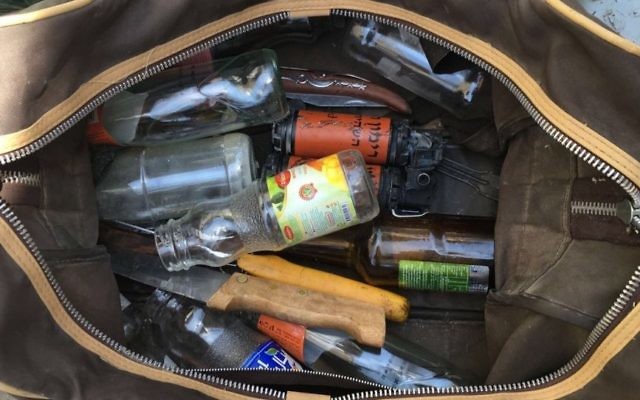 A bag of knives, stun grenades, and Molotov cocktail materials confiscated from a Palestinian vehicle at the Mazmoria checkpoint outside Bethlehem. (Police spokesperson) A bag of knives, stun grenades, and Molotov cocktail materials confiscated from a Palestinian vehicle at the Mazmoria checkpoint outside Bethlehem. (Police spokesperson)