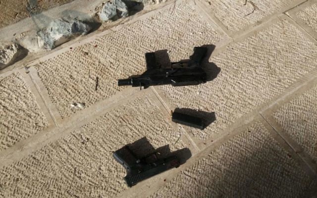 A pistol and one of two Carlo-style submachine guns used in a shooting attack that left two Israeli seriously wounded near the Temple Mount in Jerusalem's Old City on July 14, 2017. (Israel Police) A pistol and one of two Carlo-style submachine guns used in a shooting attack that left two Israeli seriously wounded near the Temple Mount in Jerusalem's Old City on July 14, 2017. (Israel Police)