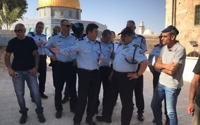 Israel Police Commissioner Roni Alsheich, center-right, speaks with Jerusalem Police chief Yoram Halevi, center, on the Temple Mount, following a terror attack nearby on July 14, 2017. (Israel Police)