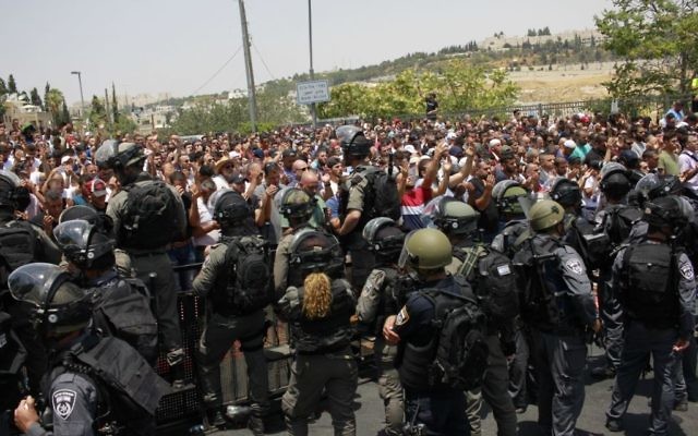 Israeli security forces stand guard in front of Palestinian Muslim worshipers outside Lions Gate , July 21, 2017. (Judah Ari Gross/Times of Israel)