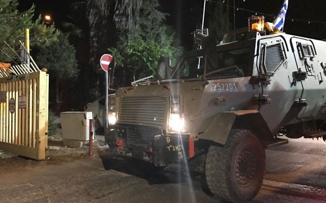 An armored IDF vehicle arrives at the West Bank settlement of Halamish on July 22, 2017, following a deadly terror attack. (Jacob Magid/Times of Israel) An armored IDF vehicle arrives at the West Bank settlement of Halamish on July 22, 2017, following a deadly terror attack. (Jacob Magid/Times of Israel)