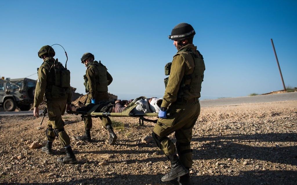 In this undated photo provided on July 19, 2017, IDF soldiers evacuate a wounded Syrian in the area of the Golan Heights. (IDF spokesperson)