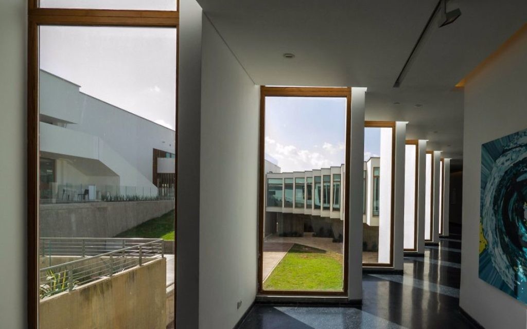 The corridor to the rooms of the hotel, with a glimpse of the gallery art on the walls (Courtesy Amnon Rechter)