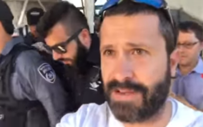 Rabbi Jeremy Gimpel being escorted by police officers at the Temple Mount in Jerusalem, July 19, 2017. (Screen capture: YouTube) Rabbi Jeremy Gimpel being escorted by police officers at the Temple Mount in Jerusalem, July 19, 2017. (Screen capture: YouTube)