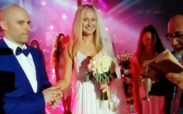 Canadian hockey player Avi Steinberg and his girlfriend of four years, and recent convert to Judaism, Rachel Dixon, get married at the opening ceremony of the Maccabiah 20th Games in Jerusalem, July 6, 2017. (Screenshot)